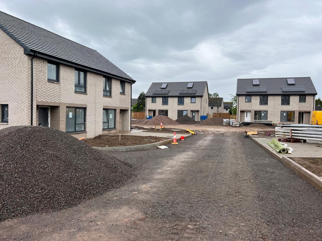 Ongoing construction at the Wheatley Development in Springholm, showcasing new semi-detached homes with energy-efficient features such as solar panels.